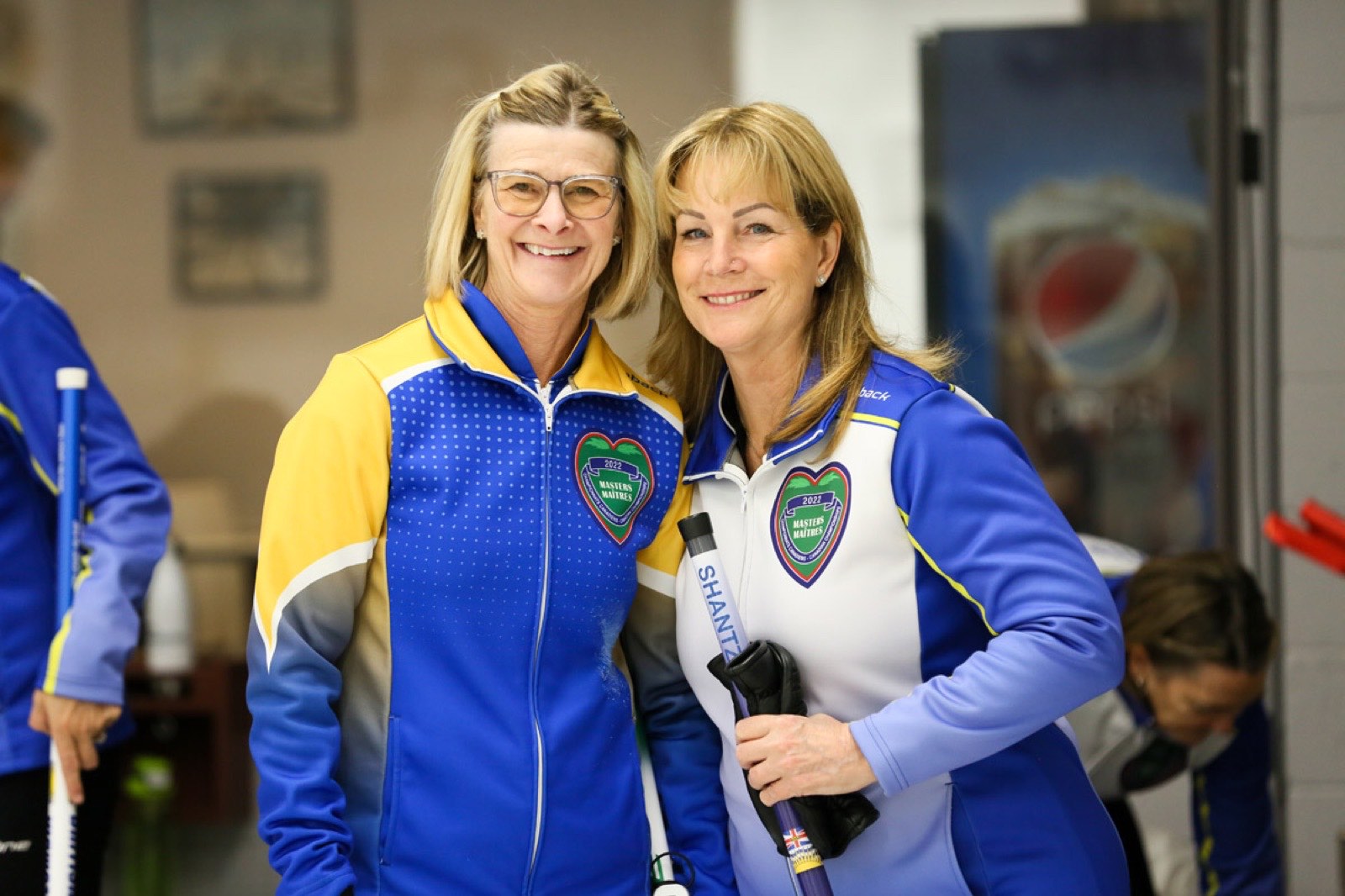 Penny, an Alberta curler, sharing a hug with a fellow competitor